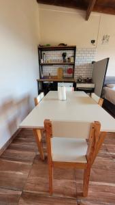 a white table and chairs in a room at Astrolabio Hostel in San Carlos de Bariloche