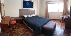 a bedroom with a bed with two pillows on it at APARTAMENTO, CENTRO DE LA CUIDAD in Cochabamba