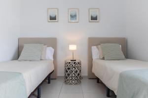 two beds sitting next to each other in a room at Villa Serenity in Tías +36 photos