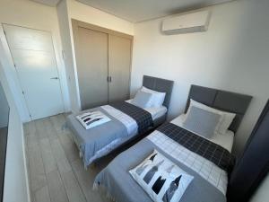 A bed or beds in a room at Ocean Garden Sunset Apartment - heated swimming pool Free WIFI