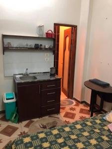 a kitchen with a sink and a table in a room at Sunny sea in Quseir