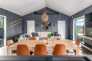 a dining room with a wooden table and chairs at Hytte Trysil SPA in Trysil