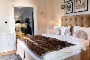 a bedroom with a bed with a brown blanket on it at NOFO Hotel, WorldHotels Crafted in Stockholm
