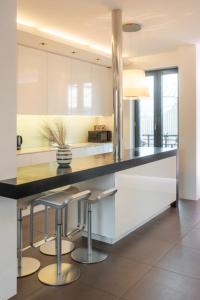 a kitchen with a black counter and stools in it at Stay Iceland apartments - S 46 in Reykjavík