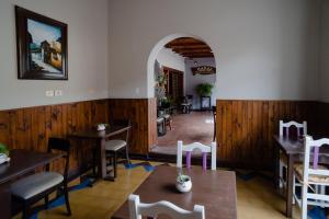 a restaurant with wooden walls and tables and chairs at Munay San Salvador de Jujuy in San Salvador de Jujuy