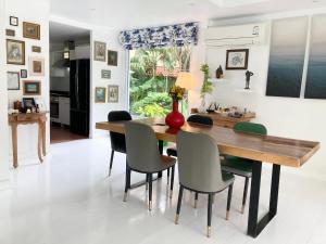 a dining room with a wooden table and chairs at 4 Bedroom Samui Family Pool Villa in Bophut 