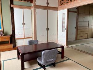 a dining room with a table and two chairs at SPR港家 in Kamuenai