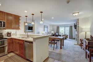 an open kitchen and living room with a dining room at Seasons at Avon, A Vail Resorts Property in Avon