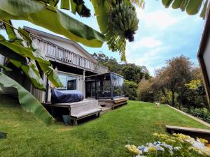 a house with a view of a yard at Garden Bliss & Bird Sanctuary in Paihia Estuary in Paihia