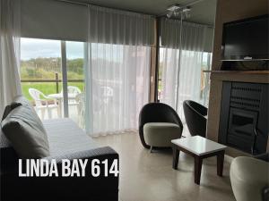 a living room with a bed and a fireplace at Linda Bay 614 in Mar de las Pampas