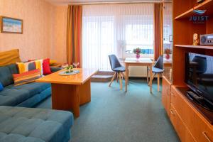 a living room with a couch and a table at Haus Petra 131 - Ferienwohnung 1 in Juist