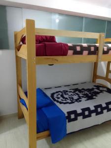 a bunk bed in a room with a blue bed at Small House in Cusco