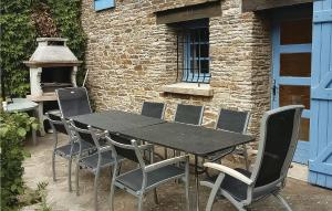 a black table and chairs in front of a brick building at Awesome Home In Lamalou Les Bains in Lamalou-les-Bains