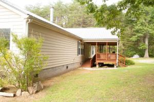 a house with a porch with a deck on it at Home on 30 acres next to State Park in Sampson