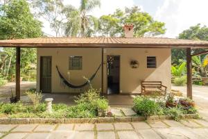 a small house with a hammock in front of it at Hotel Boutique Pé Da Tartaruga in Teresópolis