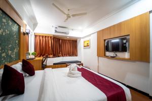 Ένα ή περισσότερα κρεβάτια σε δωμάτιο στο Hotel Kewal
