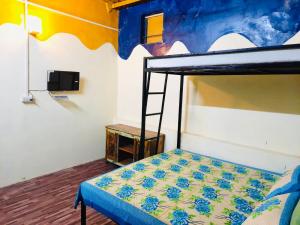 a bedroom with a bunk bed with a ladder at Housetel in Jaipur