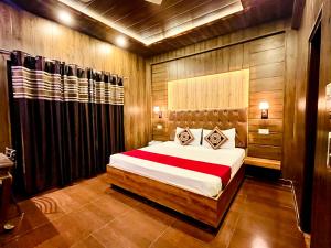 a bedroom with a large bed with wooden walls at Vanshika homes Near mall road in Kasauli