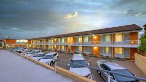 a row of cars parked in front of a building at Goulburn Central Motel in Goulburn