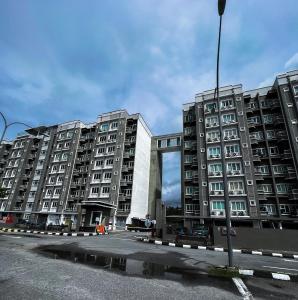 two large apartment buildings in a parking lot at Ins Apartment Langkawi Simfoni Beliza KUAH in Kuah