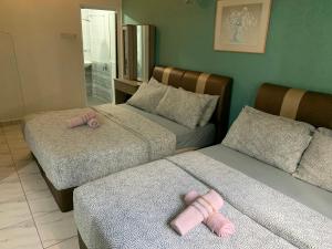 a bedroom with two beds with pink stuffed animals on them at 2 bedroom 2 bathroom Paul Serene Ramin F201 in Genting Highlands