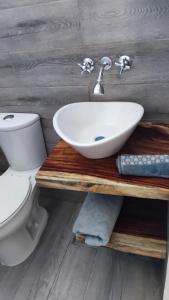 a bathroom with a sink and a toilet at Casa Sixta in Puerto Escondido