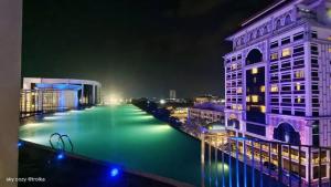 a view of a river at night with buildings at SKY COZY TROIKA RESIDENCE, 1 BEDROOM 4-6 PAX, 2 BEDROOMS 6-8 PAX, POOL VEW, SKY & CITY VIEW, Free Parking, Pool, Unlimited Wifi in Kota Bharu