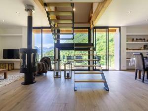 a living room with a spiral staircase in a house at Maison neuve à Grust pour 12 personnes, 4 chambres, WIFI, parking, linge et ménage inclus - FR-1-402-110 in Grust