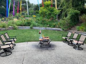 a fire pit in the middle of a garden with chairs at Amazing Santa Cruz Landscaped Paradise in Santa Cruz