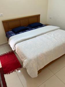 A bed or beds in a room at IP Service Apartment near Chennai Airport