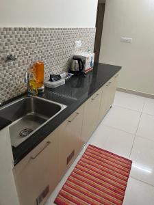 A kitchen or kitchenette at IP Service Apartment near Chennai Airport