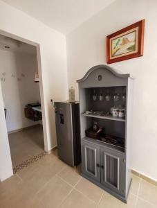 a kitchen with a stainless steel refrigerator in a room at La casita del árbol, amplia y cómoda en barrio familiar in Campeche