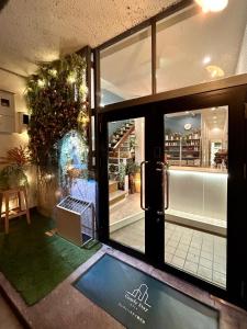 an entrance to a store with a sliding glass door at Comfy Stay Sarusawaike in Nara