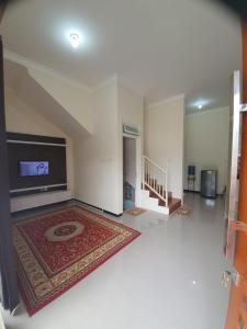 Villa Bahari Batu في باتو: غرفة معيشة كبيرة مع تلفزيون وسجادة