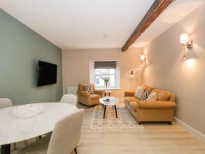 a living room with a table and chairs at Windermere in Kendal