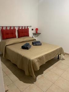 a bedroom with a large bed with two pillows on it at Casal Baratz in Santa Maria la Palma