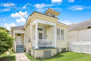 a house with a white fence in front of it at Uptown Spacious 4BD/3BA with Historic Charm in New Orleans