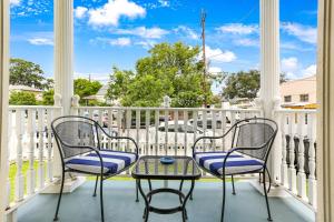 two chairs and a table on a porch at Uptown Spacious 4BD/3BA with Historic Charm in New Orleans