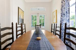 a dining room table with a vase on top of it at Uptown Spacious 4BD/3BA with Historic Charm in New Orleans