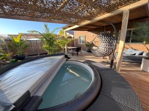 a car parked on a deck with a hot tub at Zimmer spa in megadim in Bet Ẕevi