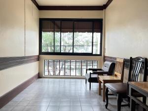 a waiting room with chairs and a large window at Seaside Palace Hotel in Koh Samui 