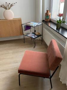 una stanza con panchina, tavolo e sedia di Cabine Congé nieuw appartement dichtbij zee a Ostenda