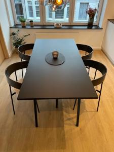 a table with chairs and a bowl on top of it at Cabine Congé nieuw appartement dichtbij zee in Ostend