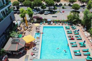 an overhead view of a swimming pool with chairs and people at Panormos Hotel in Didim