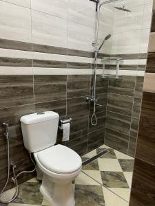a bathroom with a toilet and a shower at 3 Bedroom Family Pool Villa Flic-en-Flac Beach in Flic-en-Flac