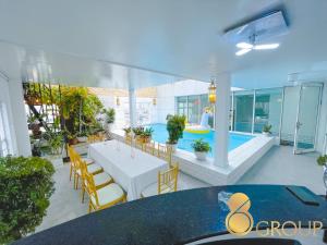 a patio with a table and chairs and a pool at White Penthouse-Rooftop Pool Private -Central City in Ho Chi Minh City