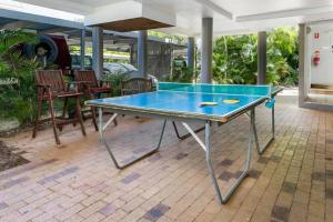 a ping pong table on a patio at Emohruo Rainbow Shores - 3 Br Resort Apartment in Rainbow Beach