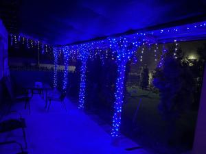 a patio with blue lights in a dark room at Agropensiunea Vila Cristina in Niculiţel