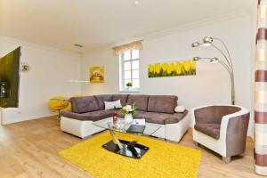 a living room with a couch and a table at Villa Livia Whg 01 in Ahlbeck