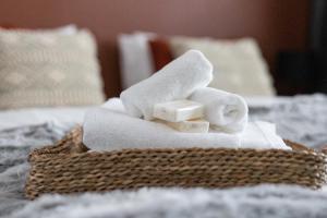 a pile of towels sitting on top of a bed at Arctic Night City Suite in Rovaniemi